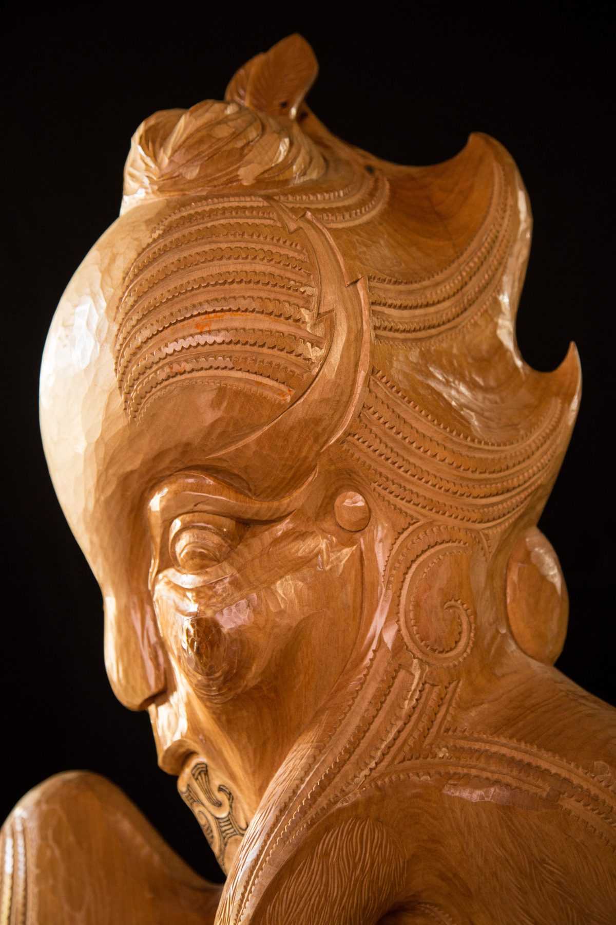 Niwareka: the head from the side, the hair carved in fine lines.
