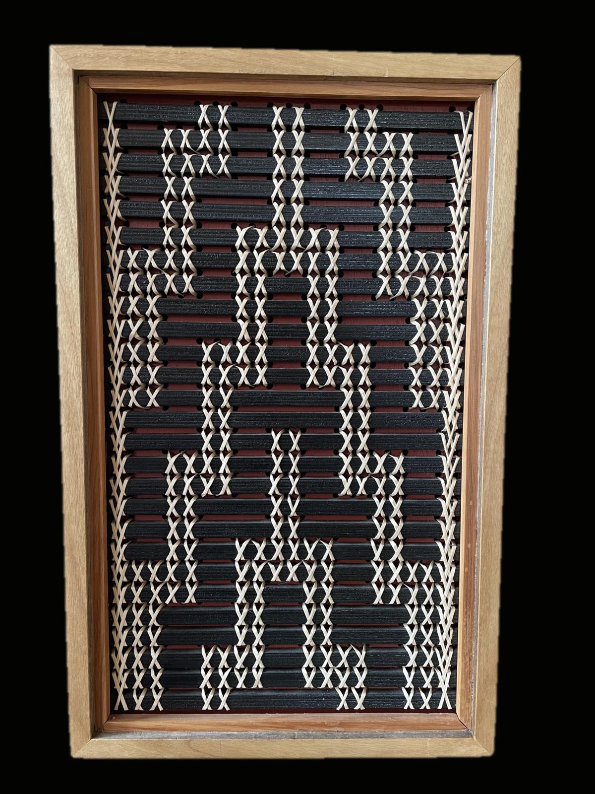 Poutama by Aka Whiro: a tukutuku panel in a mahogany and rimu frame, black slats over an ochre red board, the kiekie stitches climbing in steps.