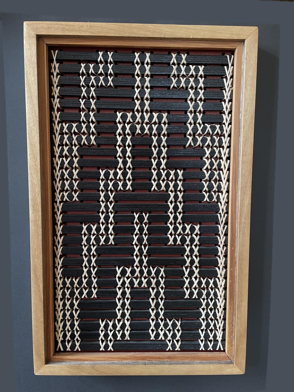 Poutama by Aka Whiro: a tukutuku panel in a mahogany and rimu frame, the kiekie stitches climbing in steps.