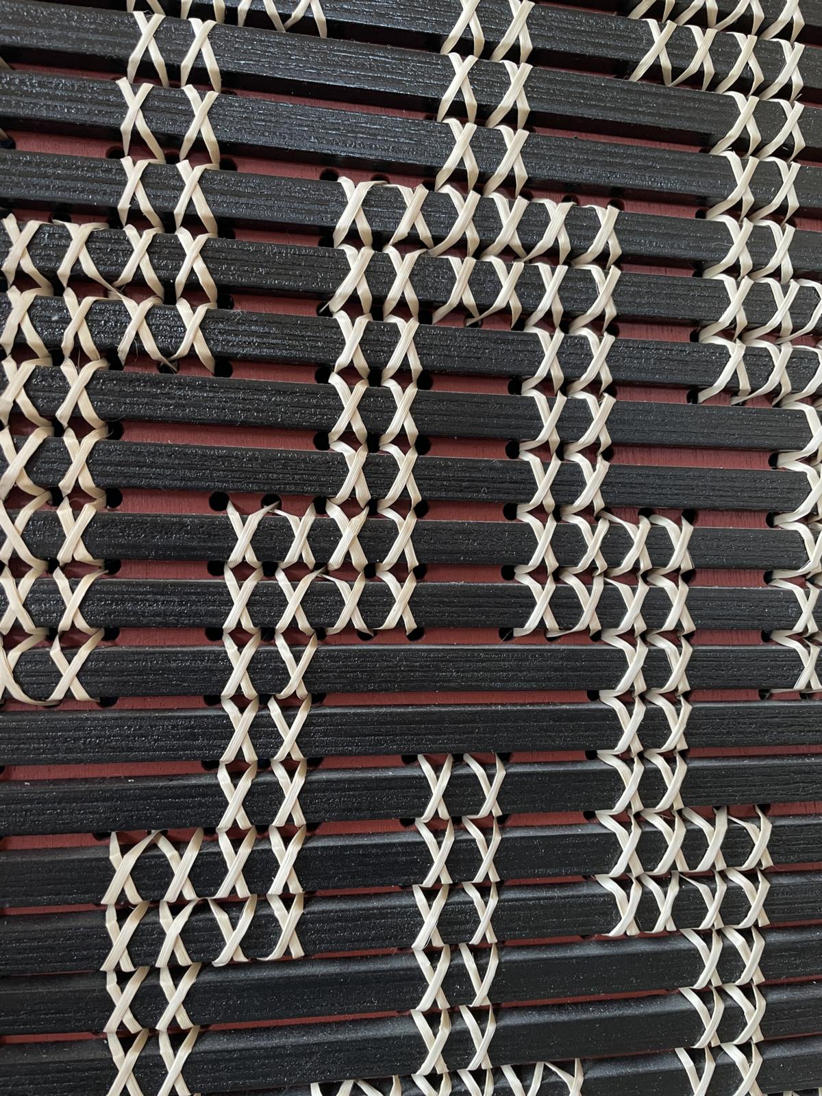 Poutama by Aka Whiro: close on the crossed kiekie stitches stepping across the black slats.