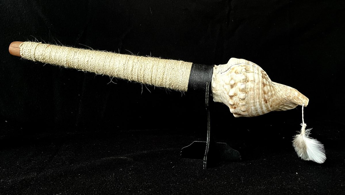 Pūtātara by Kade Cowper, front view, lit low and warm on black.