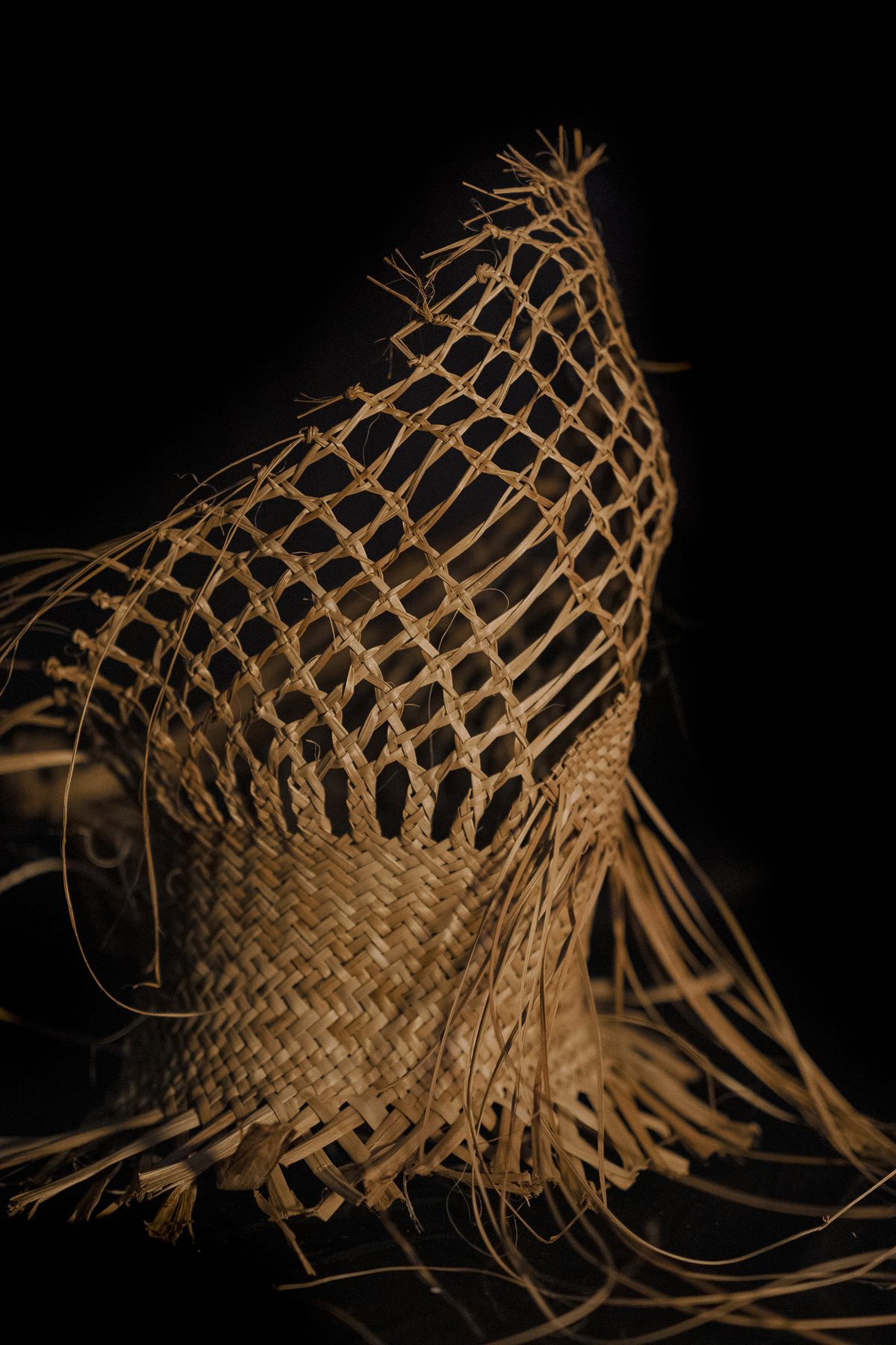 Raranga by Ruth Woodbury: the headpiece from the side, open weave above and close weave below.