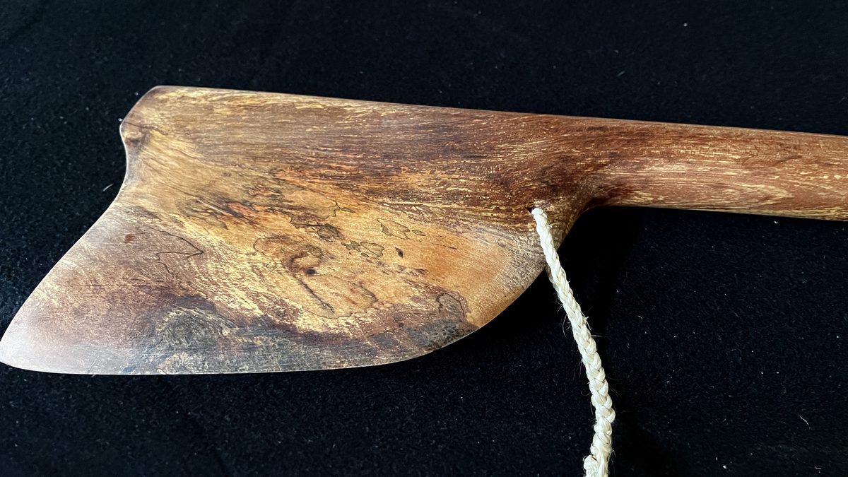 Tewhatewha by Kade Cowper: detail of the carving and the kūkupa feathers.
